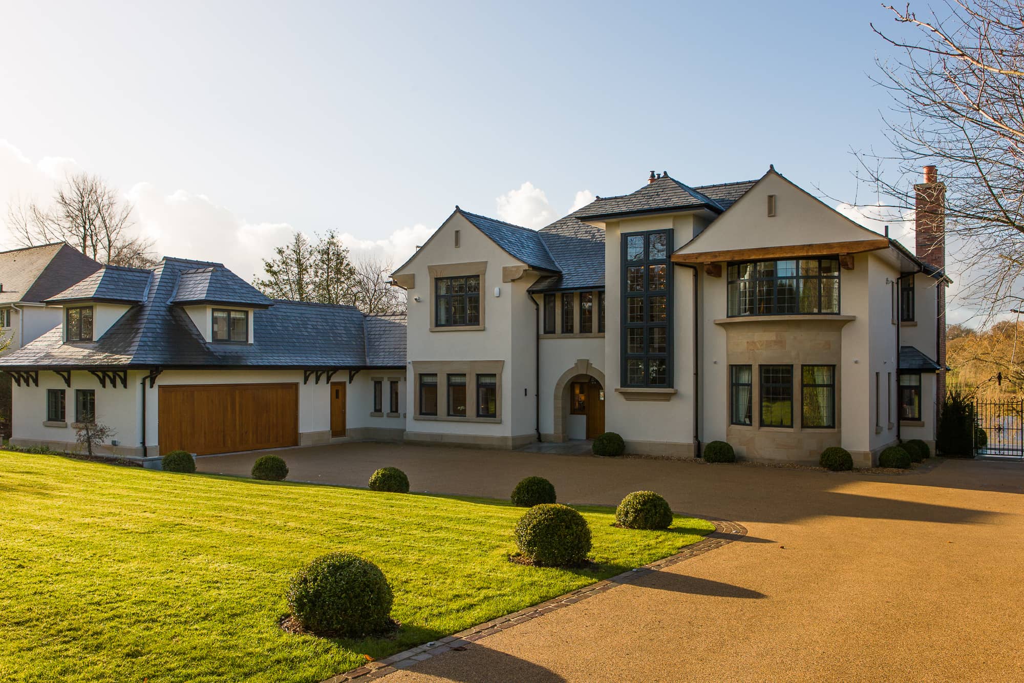a large white house with a driveway in front of it.